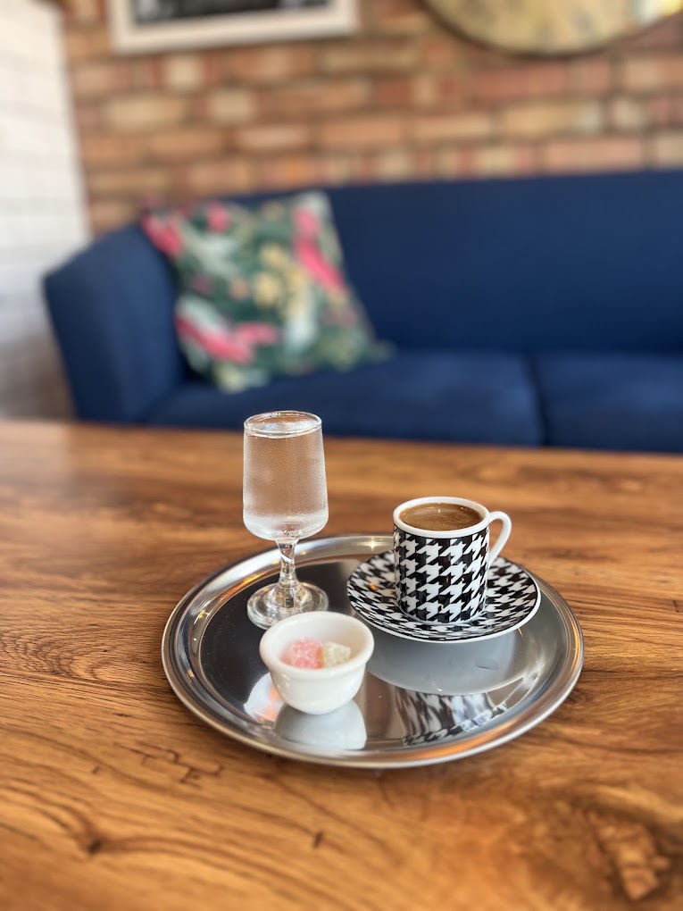 Turkish coffee and a sweet, served on a tray by the sofa seating