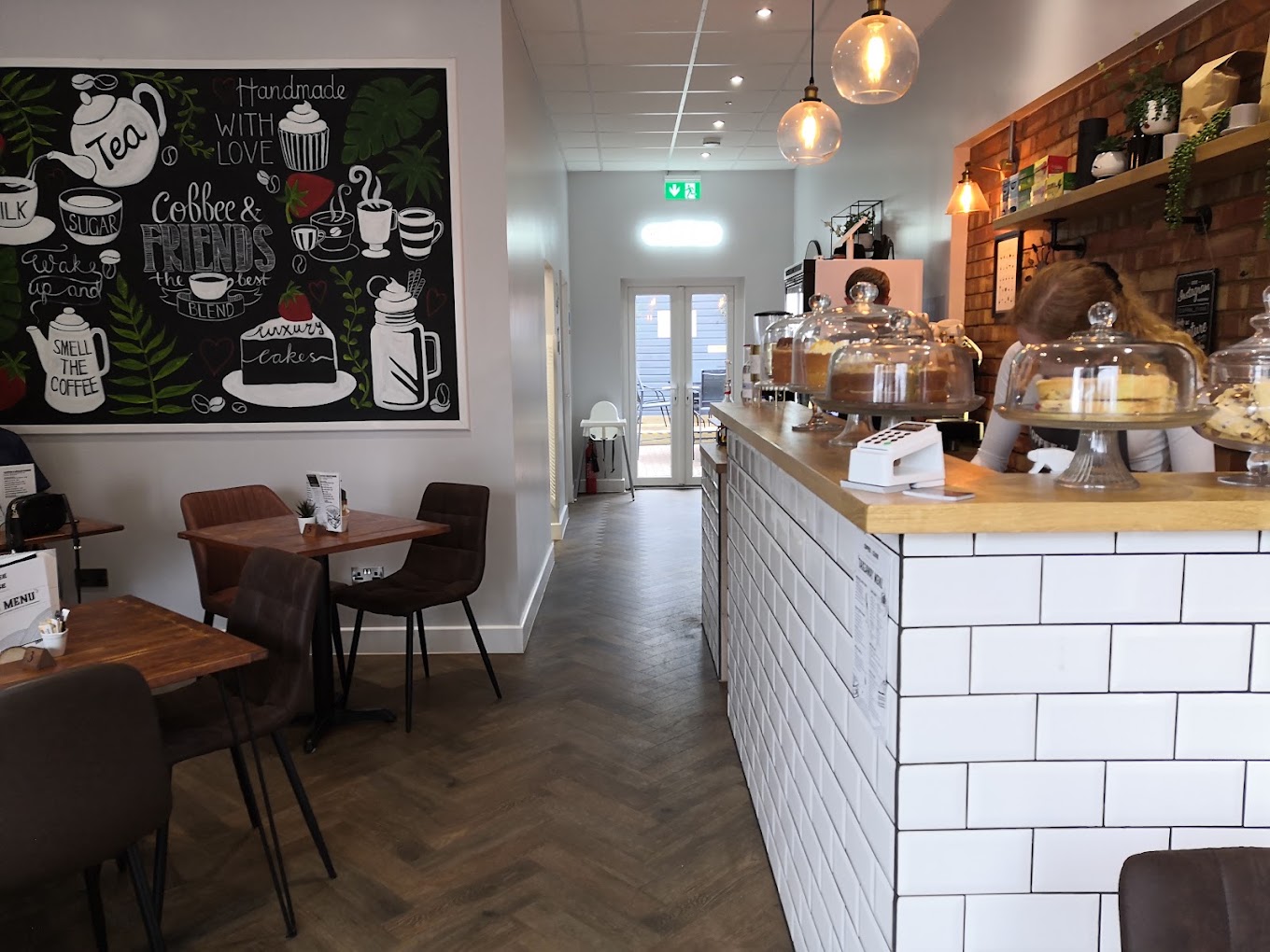 The seating area with a hand-painted mural behind the counter