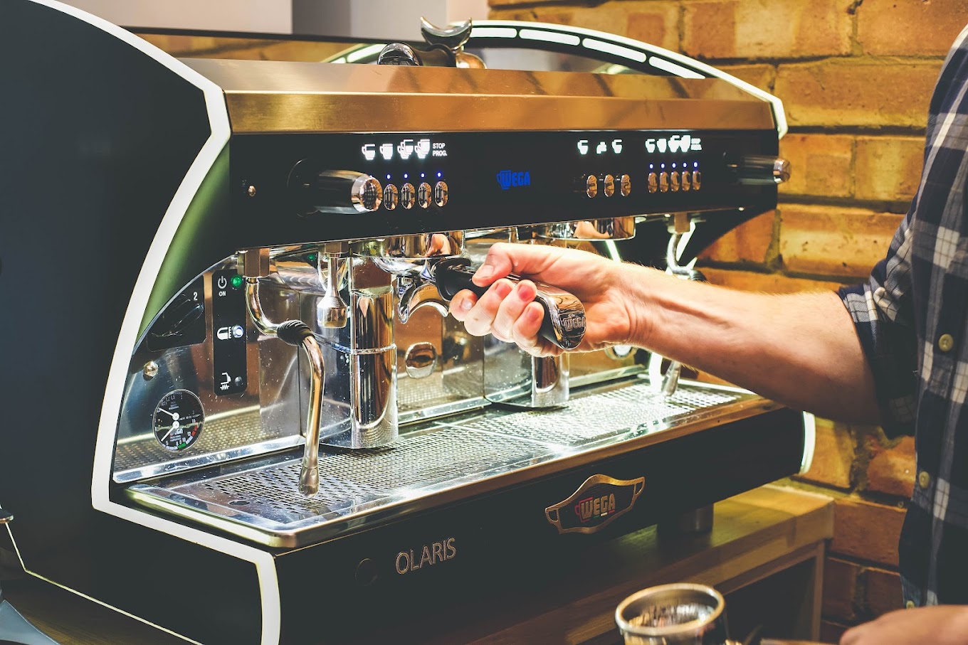 A barista pulling an espresso shot on the shop's espresso machine